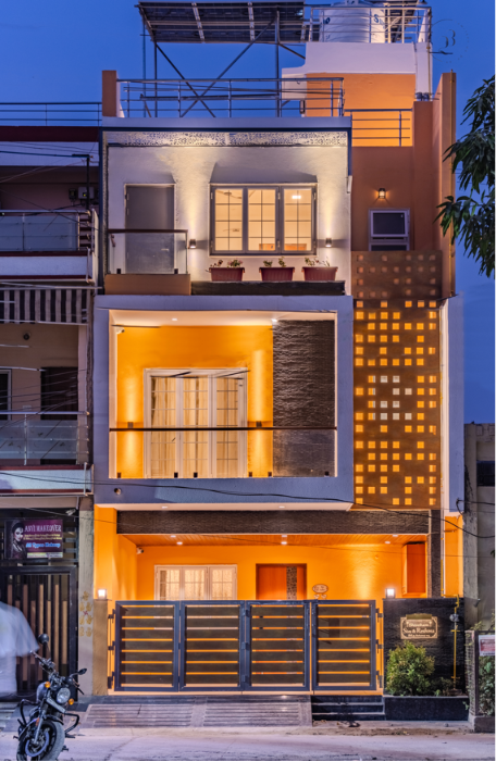 Shivom urban row house with amber night lighting — Studio23, Indore